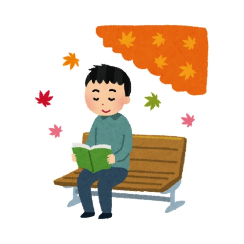 man reading a kanji book underneath a tree